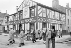 People outside Brown Cow in Cockermouth 1950s Brown Cow Inn with people walking in street